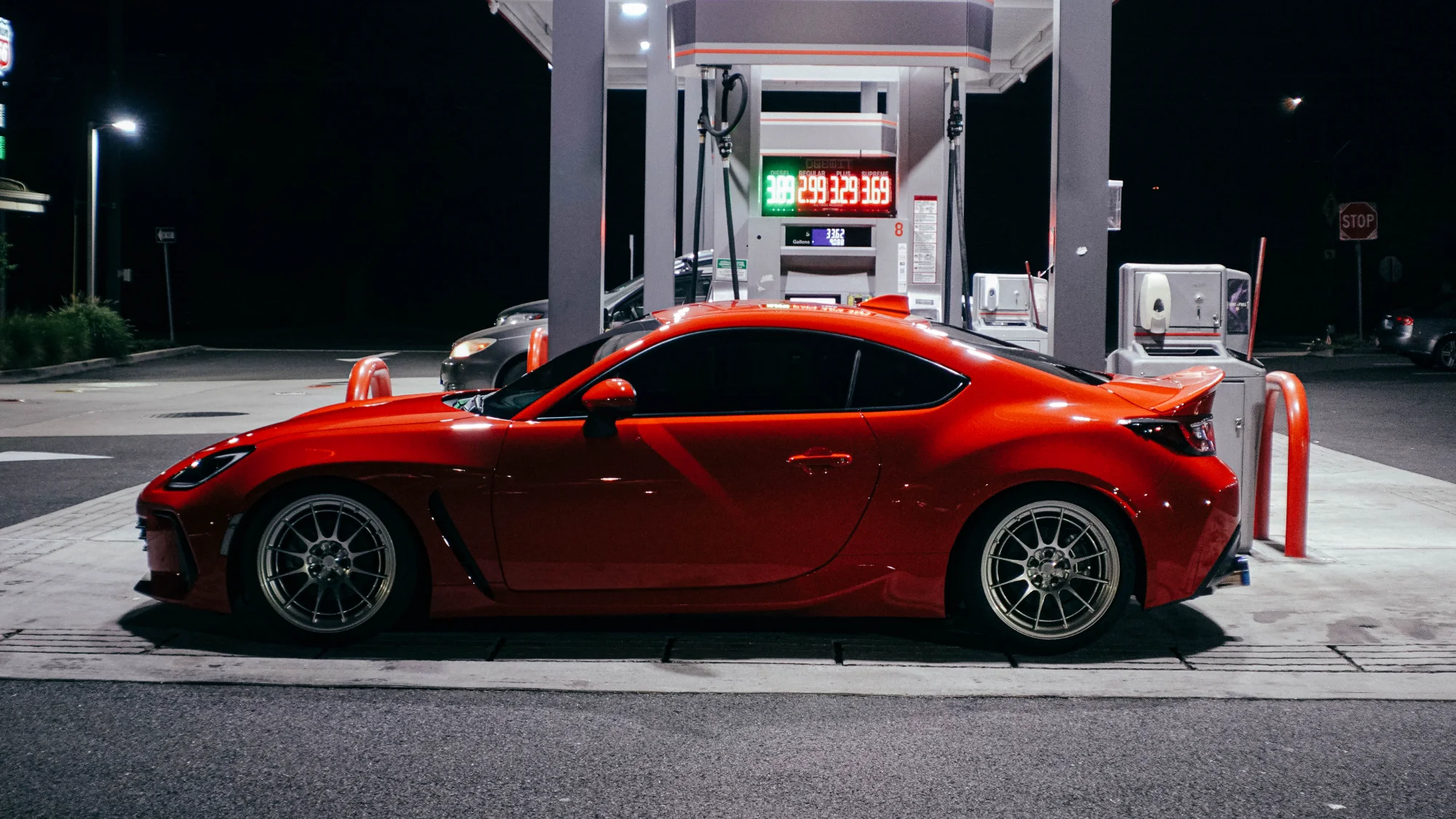 Red Subaru BRZ with Enkei wheels at night